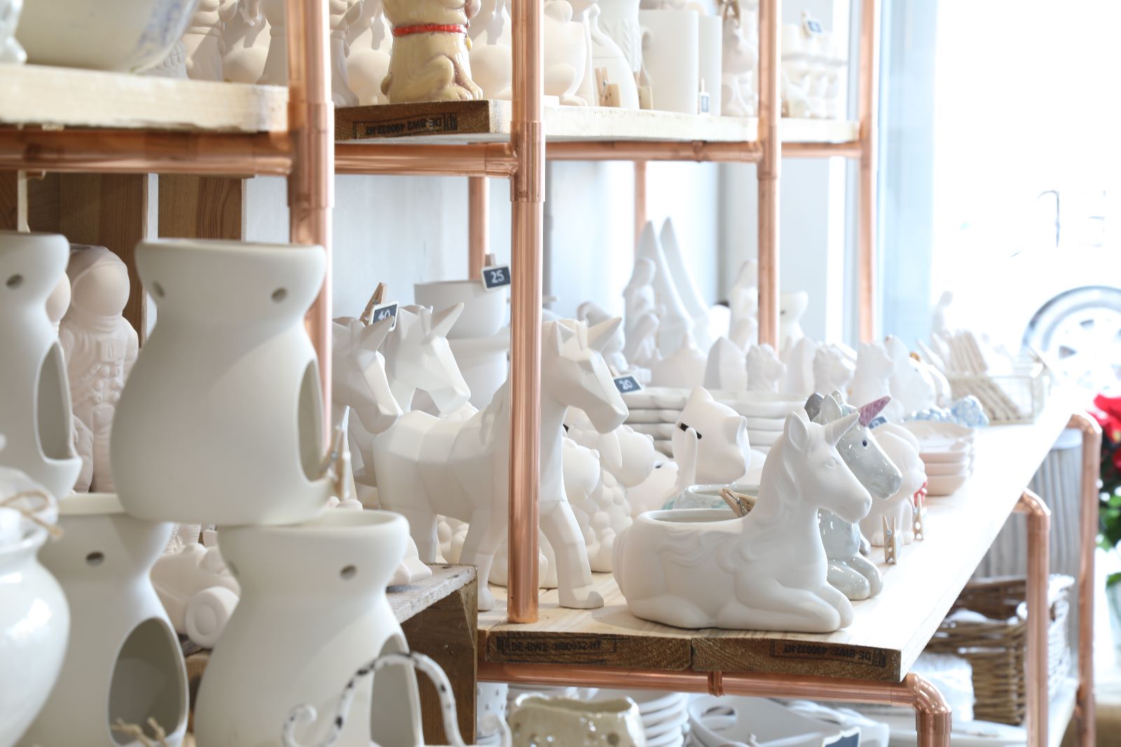 White ceramic unicorn figurines on display at Wick & Ceramic, Ickenham, London.