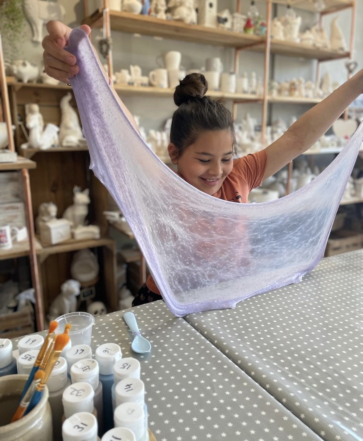child stretching their purple slime at wick and ceramic ickenham london