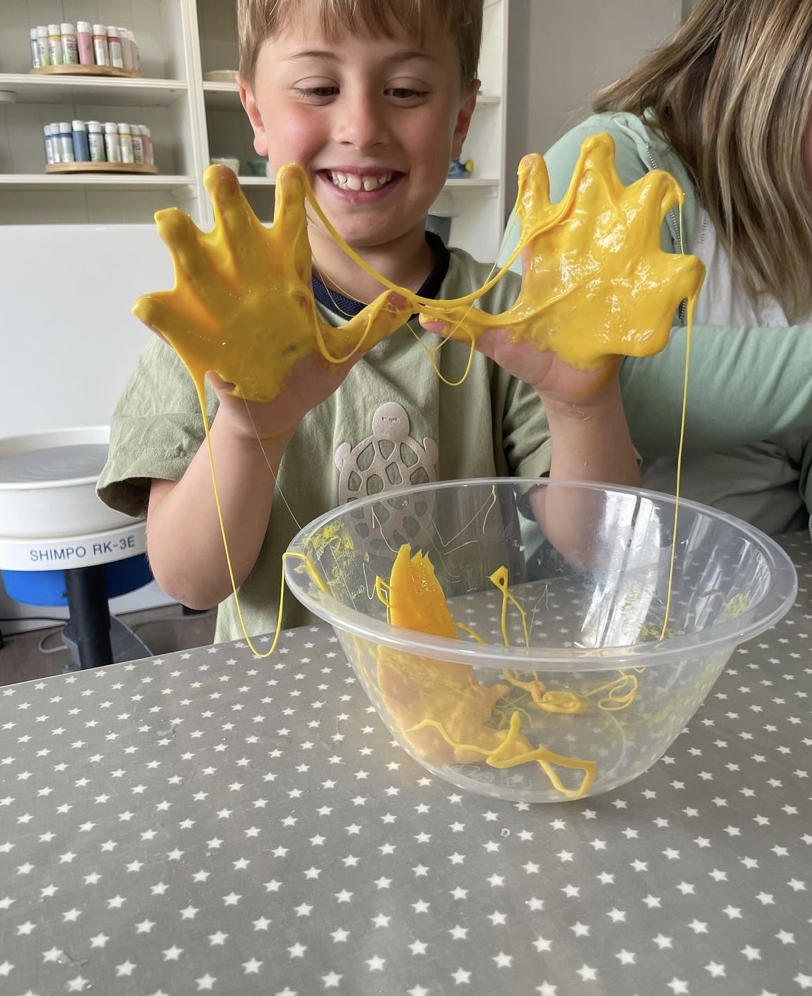 young boy playing with yellow slime party wick & ceramic ickenham london