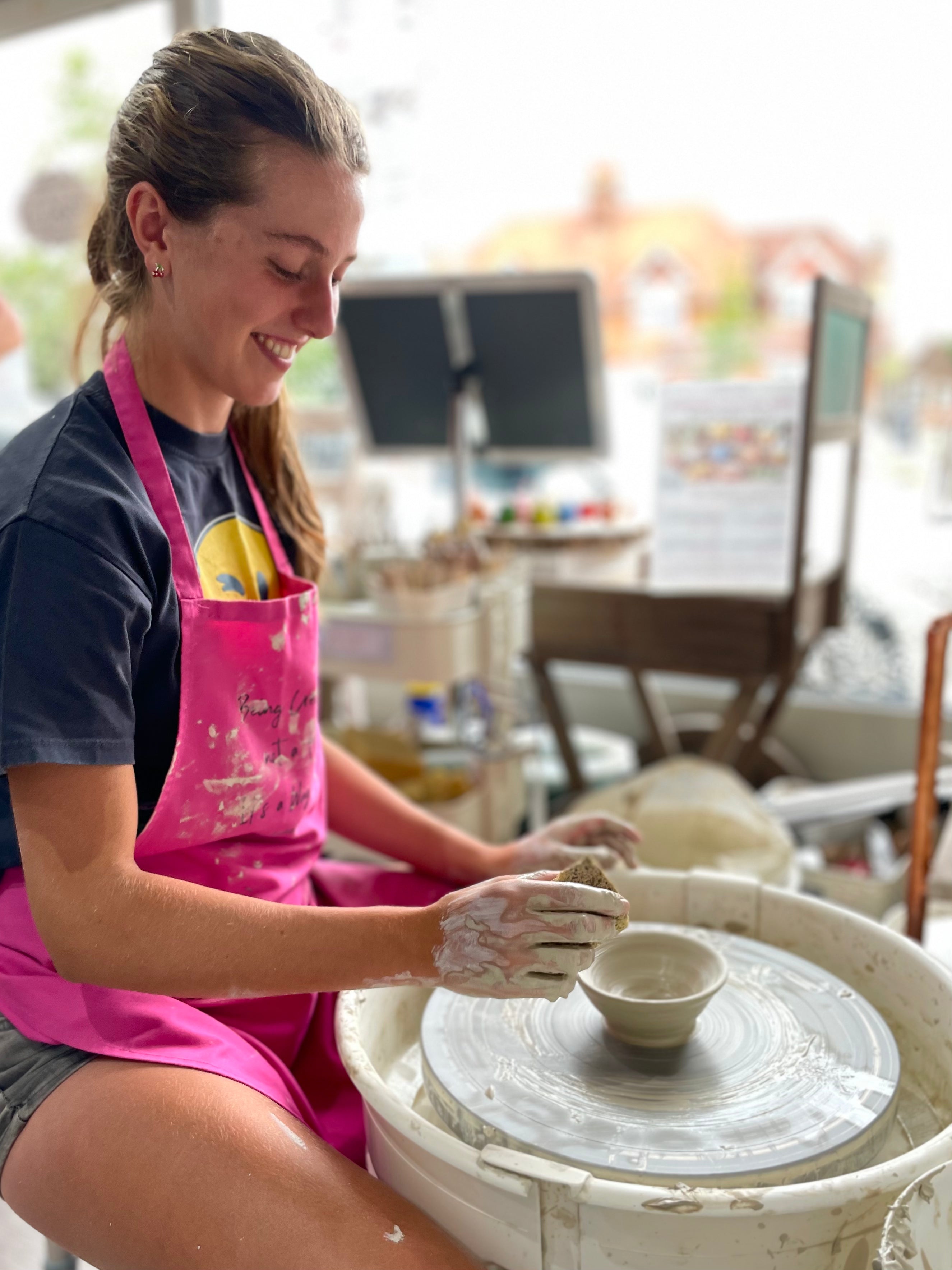 Young potter making a ceramic bowl on a wheel at wick & ceramic ickenham london
